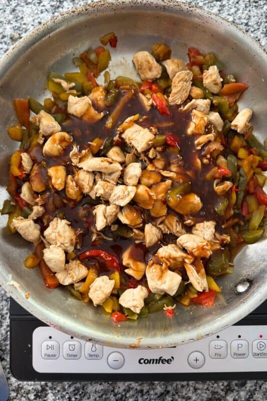 Sweet chili sauce poured over cooked chicken and veggies.