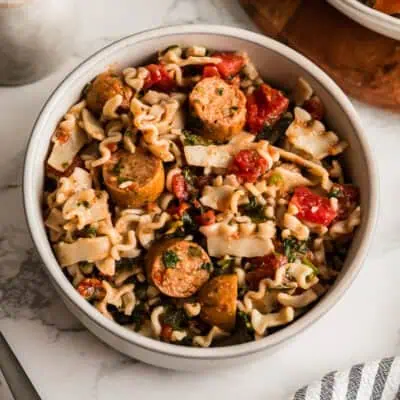 White bowl filled with chicken sausage pasta.