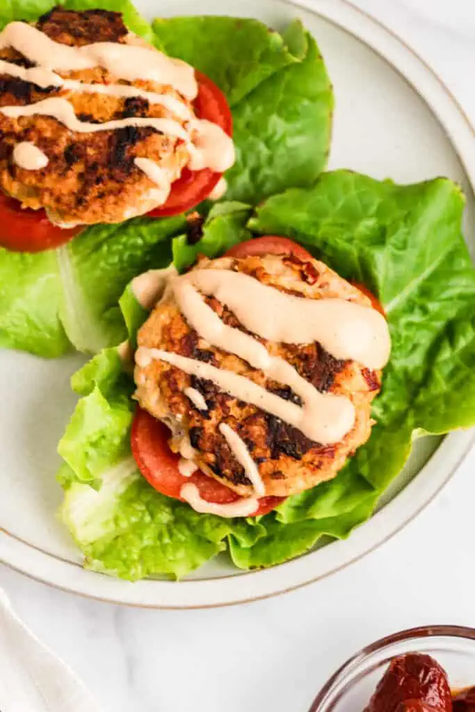 Chipotle chicken burgers on lettuce wraps. Chipotle sauce drizzled over the top.