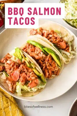 Three bbq salmon tacos on a white plate