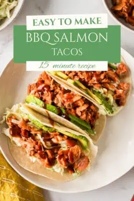 Three bbq salmon tacos on a white plate