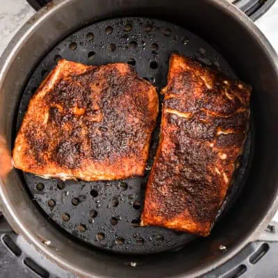 Blackened salmon in the air fryer basket.