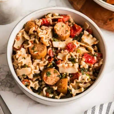 White bowl filled with chicken sausage pasta.