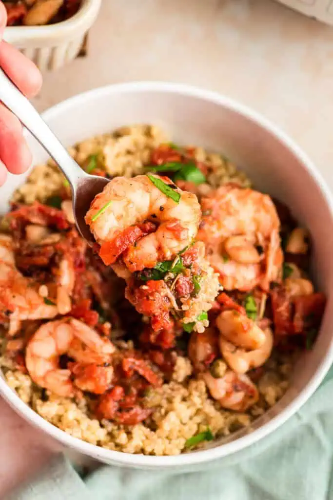 Bowl filled with Mediterranean shrimp and quinoa.