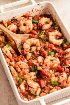 White casserole dish filled with Mediterranean shrimp recipe.