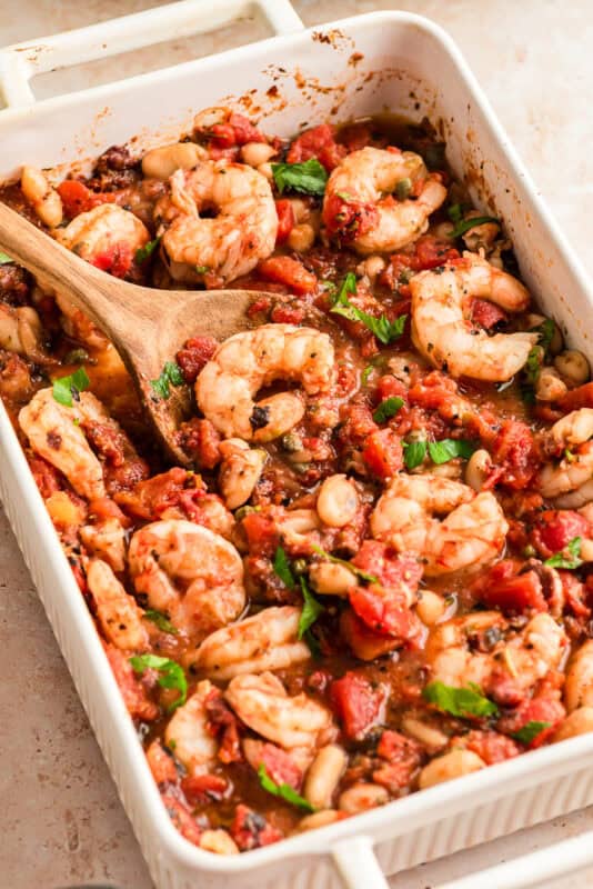 White casserole dish filled with Mediterranean shrimp recipe.