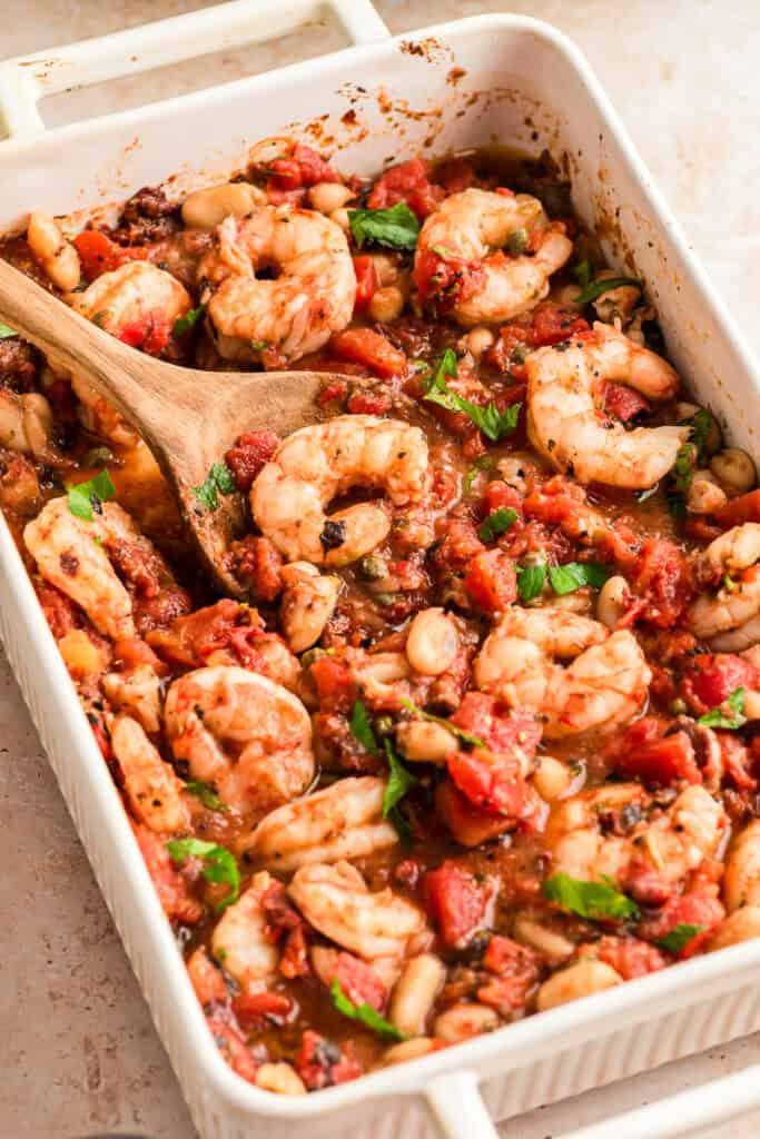 White casserole dish filled with Mediterranean shrimp recipe.