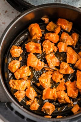 Buffalo sauce drizzled over the air fryer salmon.