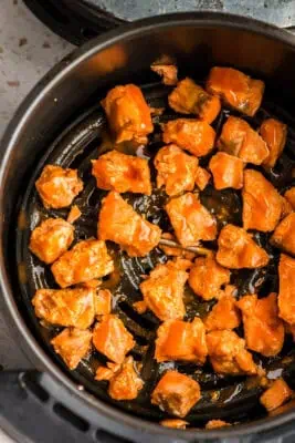 Buffalo sauce drizzled over the air fryer salmon.
