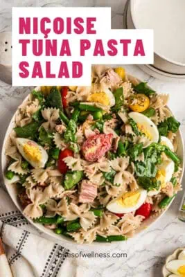 Large white bowl filled with tuna pasta salad with eggs.