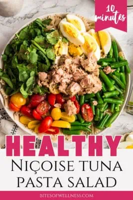 Large white bowl filled with tuna pasta salad with eggs.