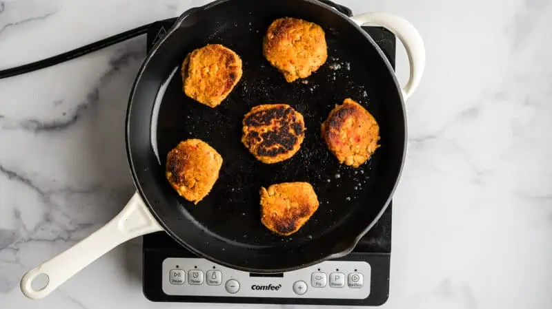 Chickpea fritters after cooking in cast iron skillet.