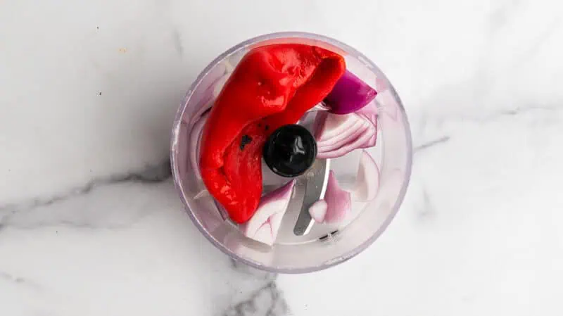 Roasted red pepper and red onion in food processor.