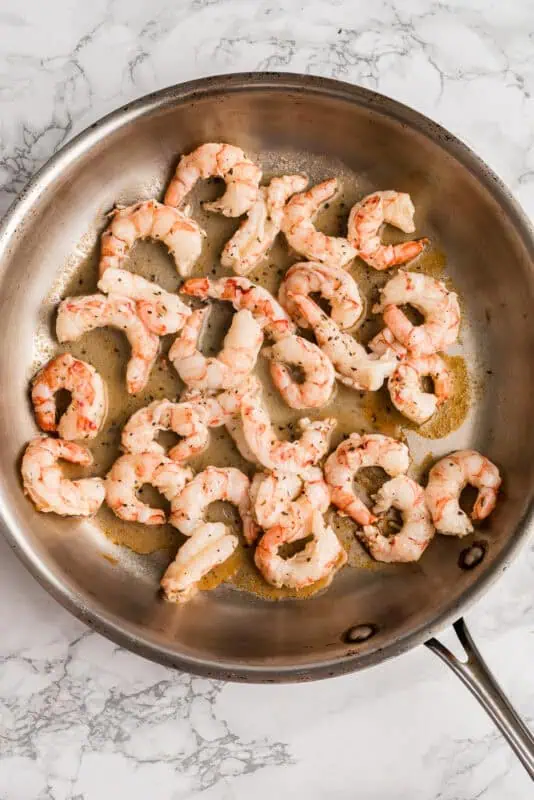 Shrimp before cooking in a stainless steel pan.
