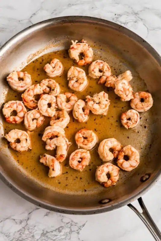 Shrimp after cooking in a stainless steel pan.