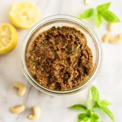 Glass jar filled with sundried tomato pesto.