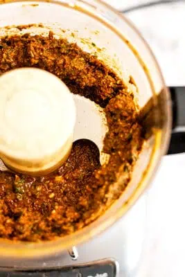 Close up of sundried tomato pesto in a food rpcoessor.