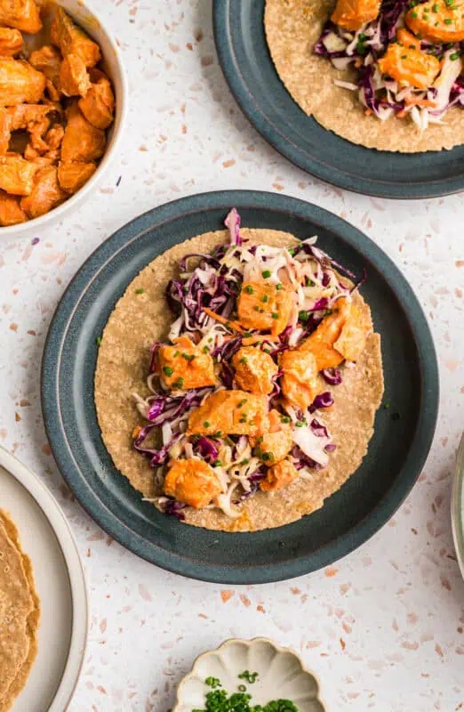Tortilla with ranch slaw and buffalo salmon on top.
